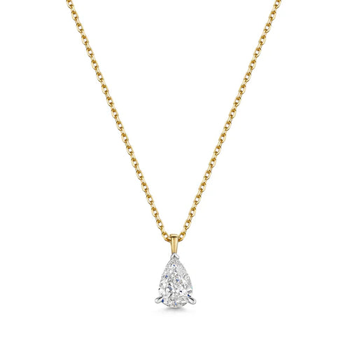 Gold chain necklace with a pear-shaped diamond pendant in prong setting on white background